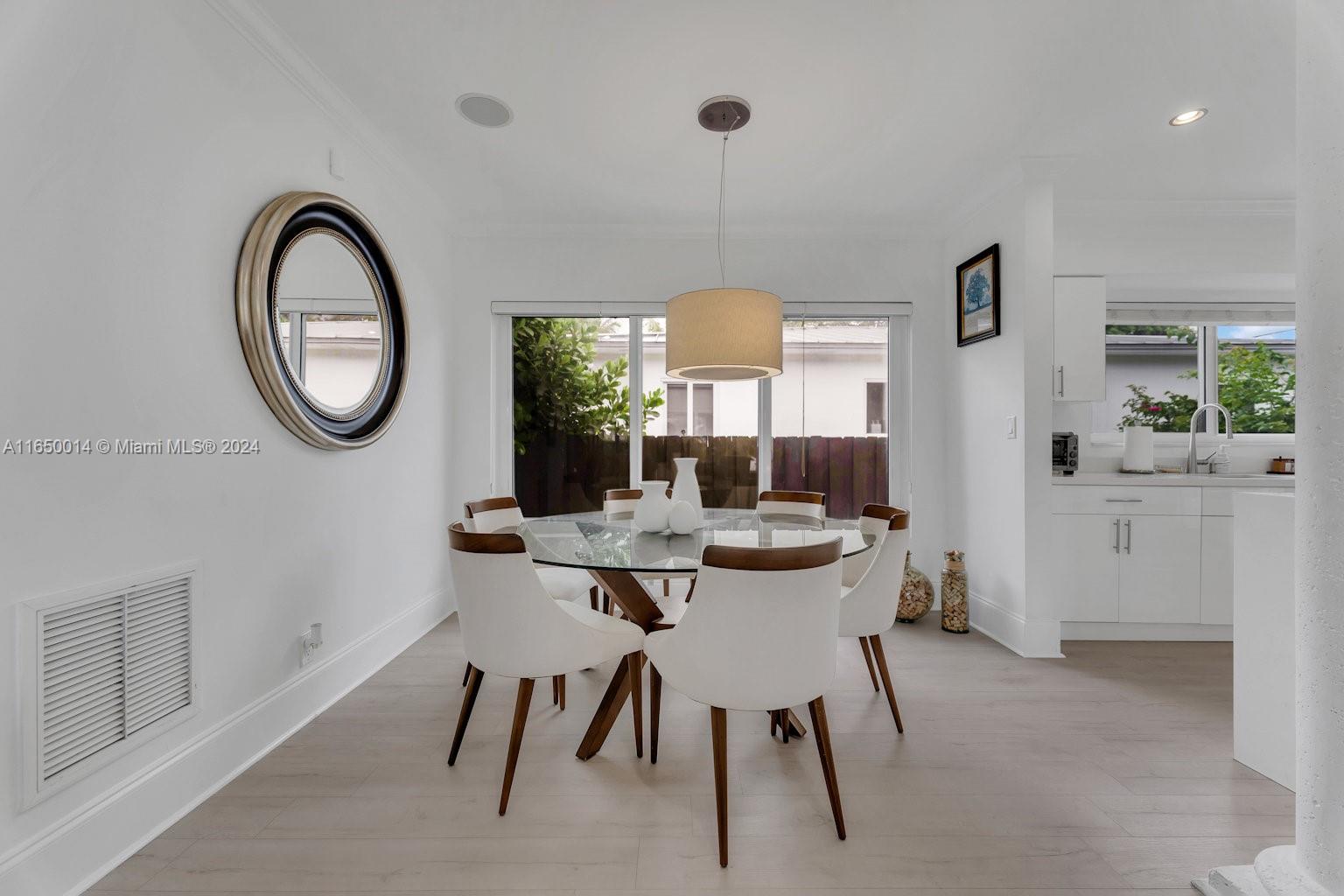 900 Surfside Boulevard Surfside, FL 33154 - Photo 16 of 38 a dining room with furniture and a mirror
