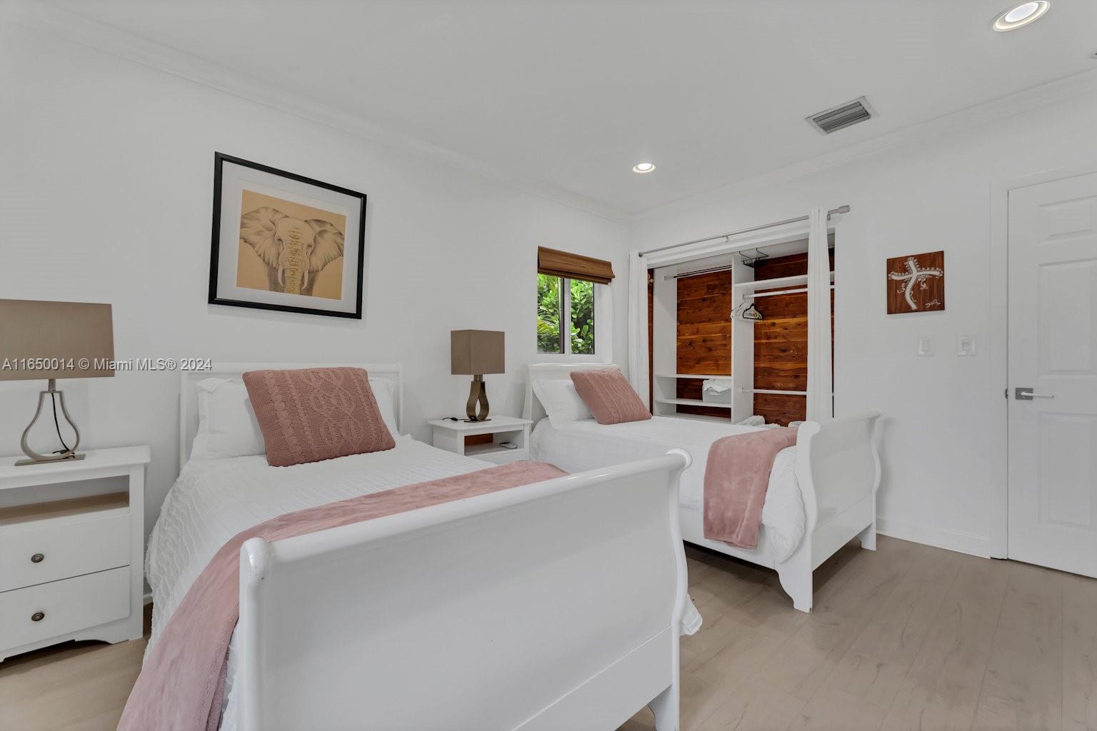 900 Surfside Boulevard Surfside, FL 33154 - Photo 18 of 38 a bedroom with bed and window