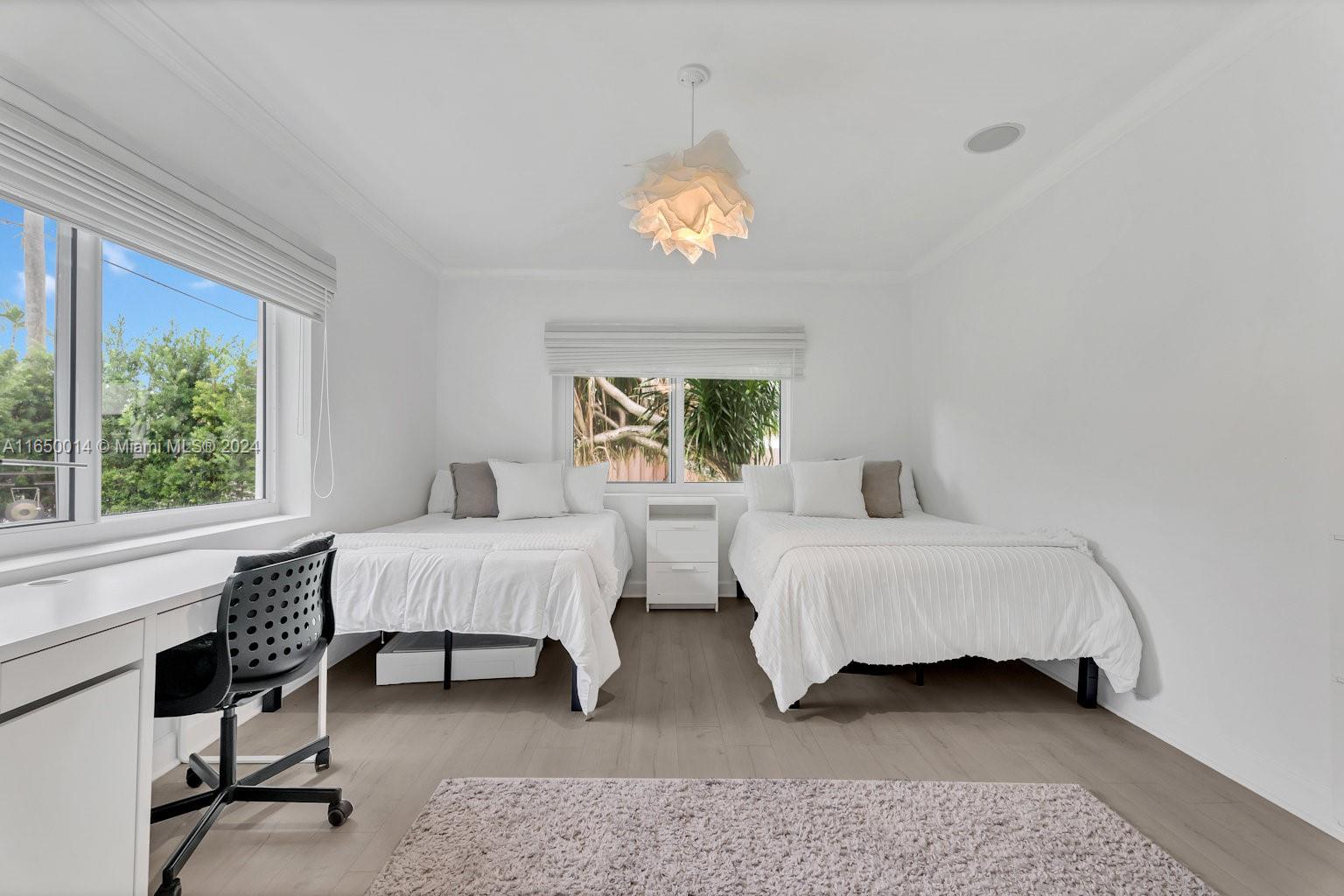 900 Surfside Boulevard Surfside, FL 33154 - Photo 21 of 38 a spacious bedroom with two beds and a window