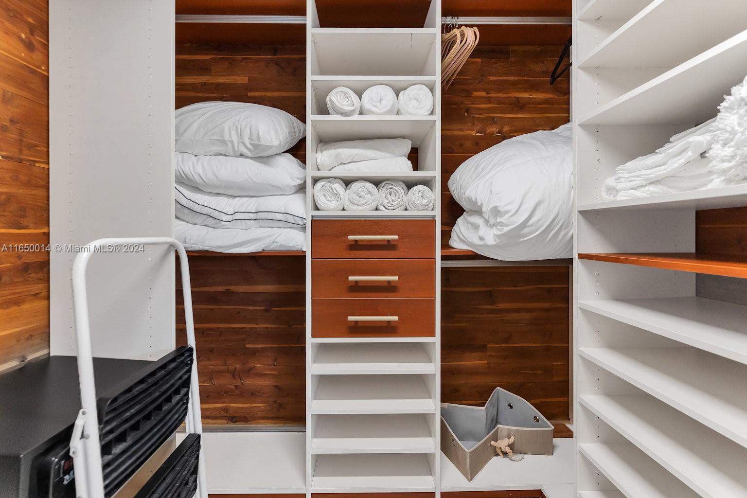 900 Surfside Boulevard Surfside, FL 33154 - Photo 25 of 38 a view of walk in closet with clothes and shoes