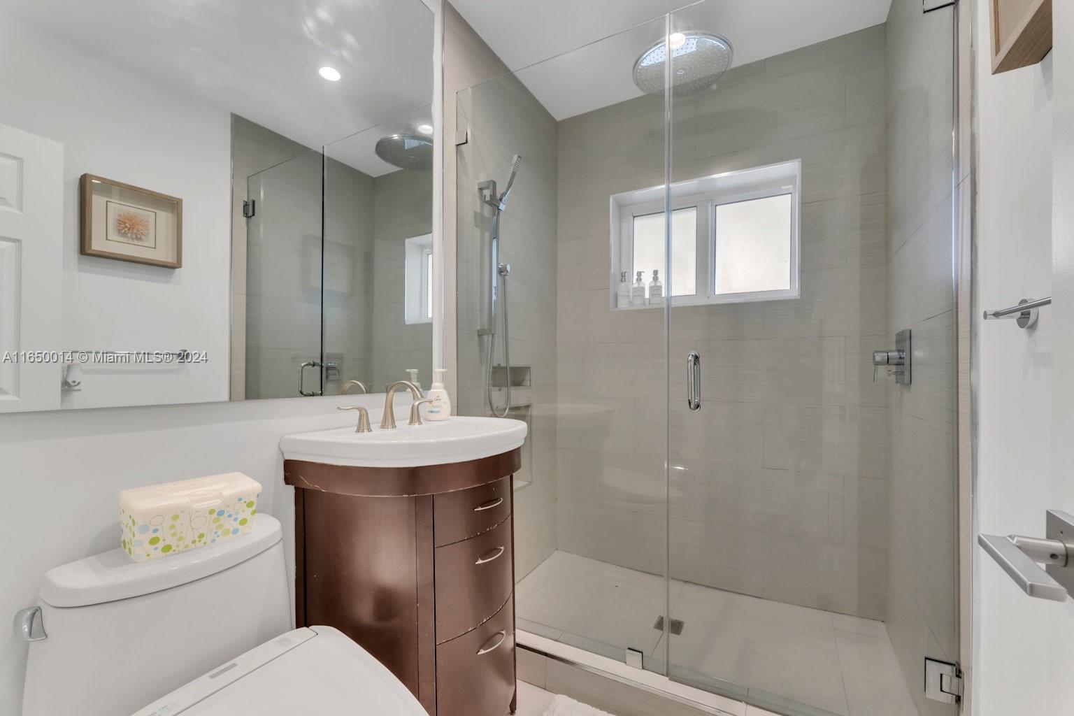 900 Surfside Boulevard Surfside, FL 33154 - Photo 26 of 38 a bathroom with a sink toilet and shower