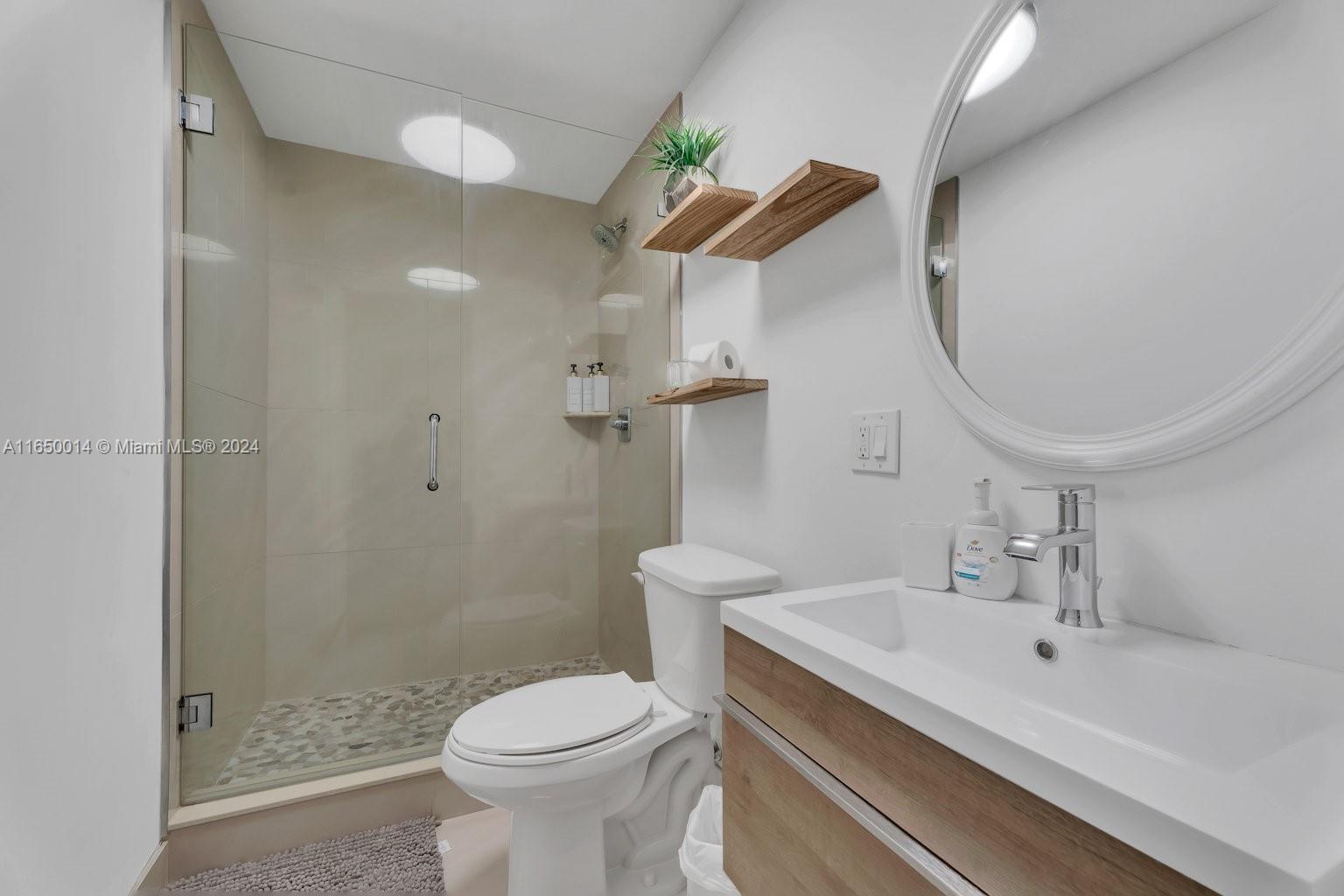 900 Surfside Boulevard Surfside, FL 33154 - Photo 28 of 38 a bathroom with a sink a toilet and shower