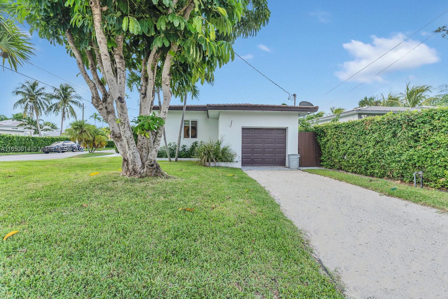 900 Surfside Boulevard Surfside, FL 33154 - Photo 32 of 38 a front view of a house with yard and green space