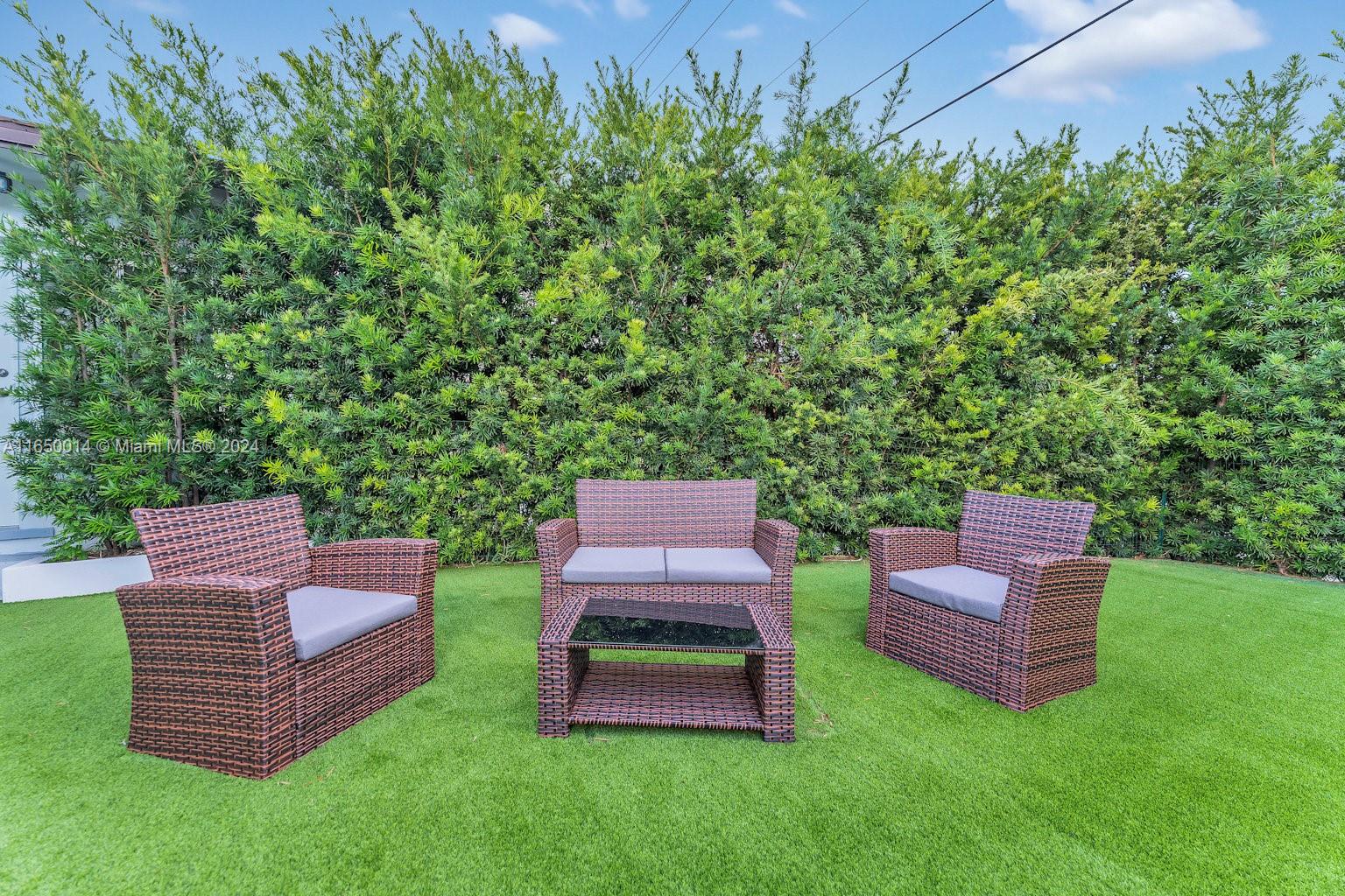 900 Surfside Boulevard Surfside, FL 33154 - Photo 35 of 38 a view of a chair and table in the garden