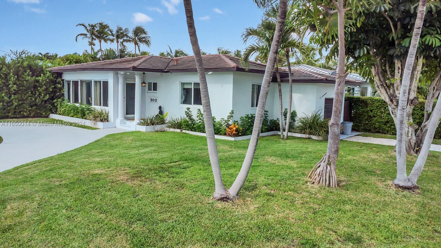 900 Surfside Boulevard Surfside, FL 33154 - Photo 7 of 38 a view of a house with backyard and a tree