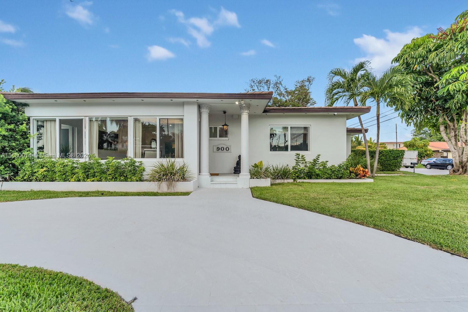 900 Surfside Boulevard Surfside, FL 33154 - Photo 8 of 38 a front view of house with yard and green space