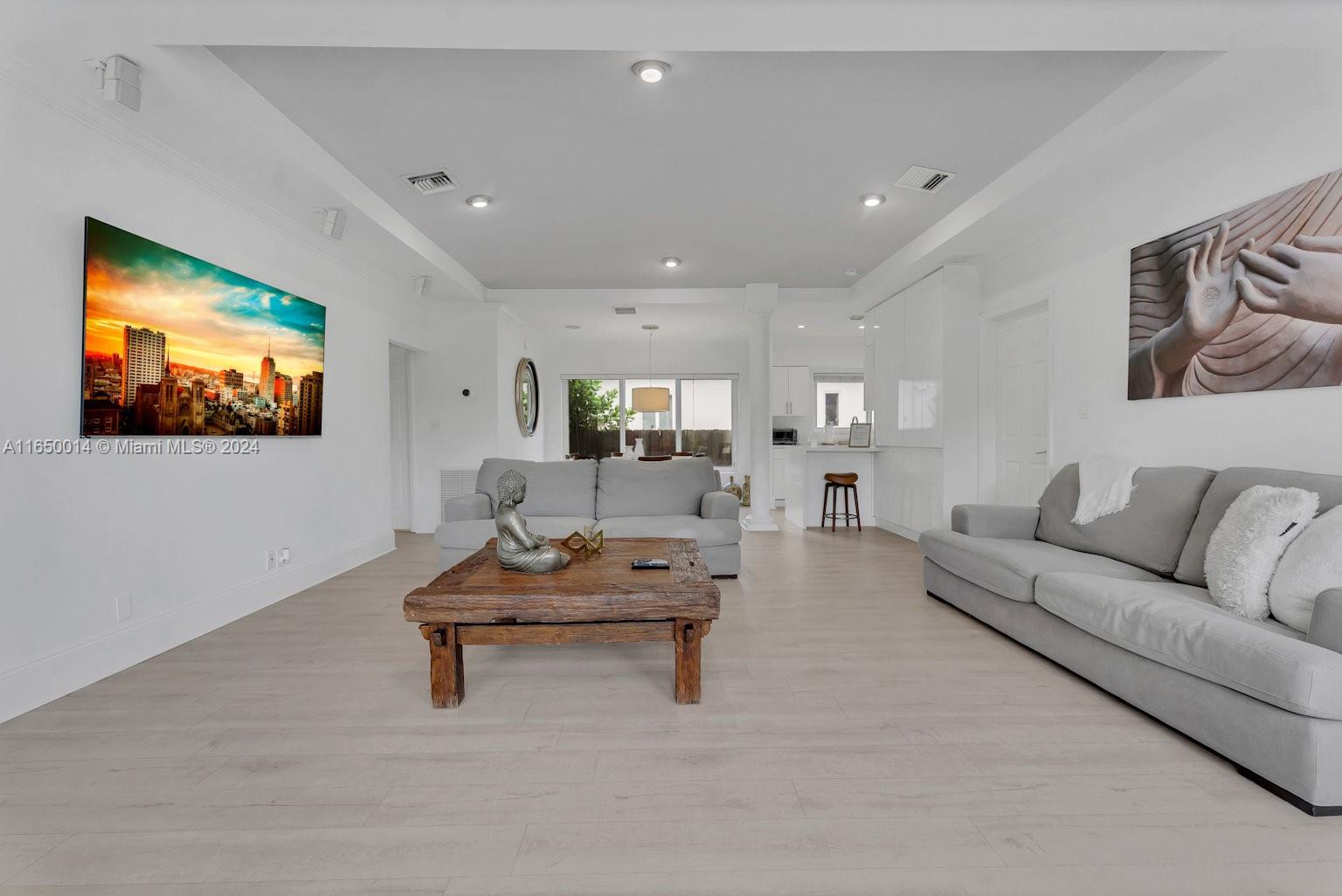 900 Surfside Boulevard Surfside, FL 33154 - Photo 9 of 38 a living room with furniture and a flat screen tv