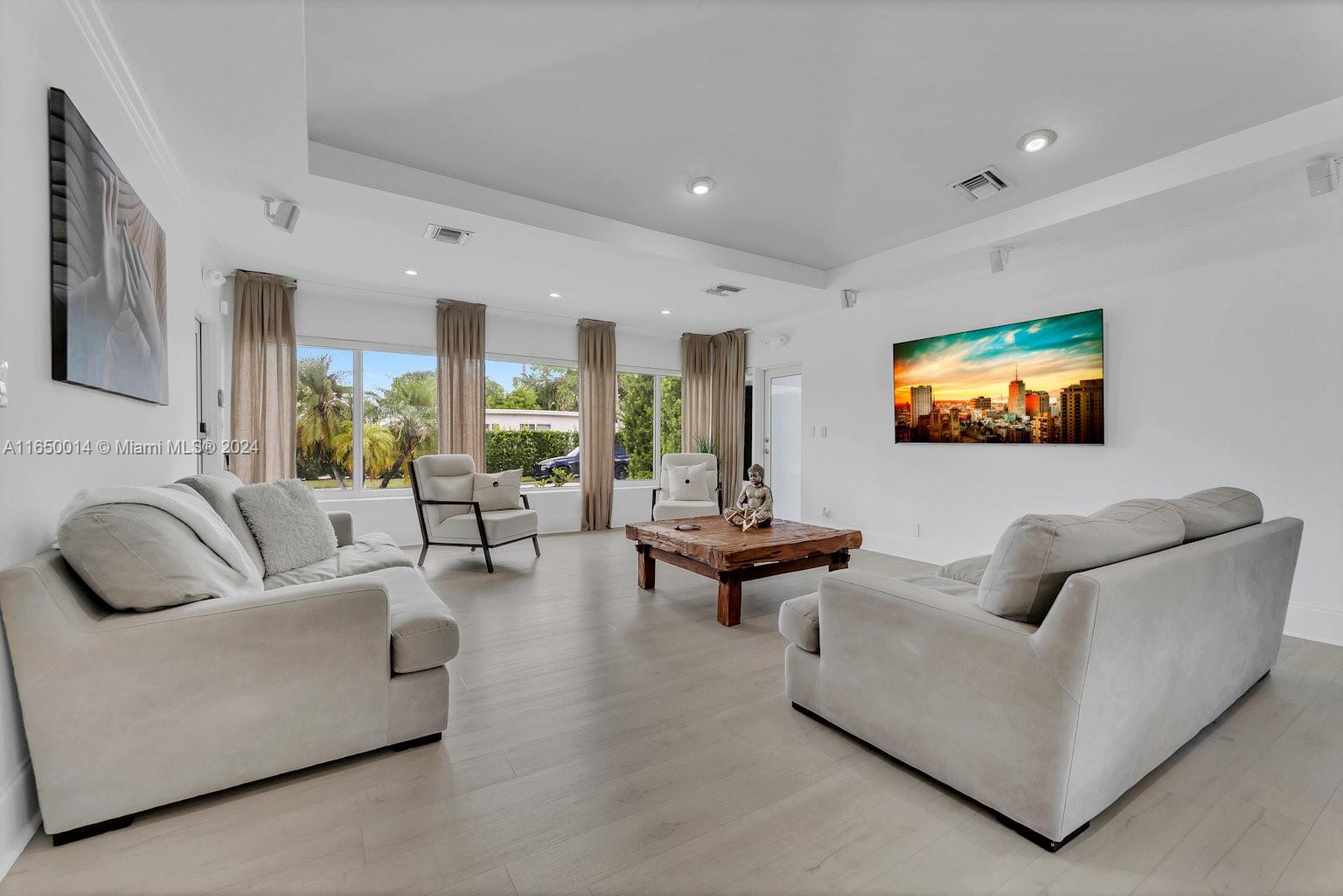 900 Surfside Boulevard Surfside, FL 33154 - Photo 10 of 38 a living room with furniture and a flat screen tv