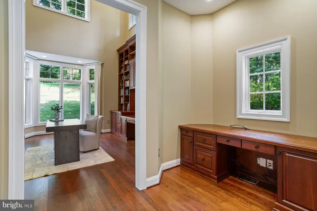 a dining room with chandelier and wooden floor