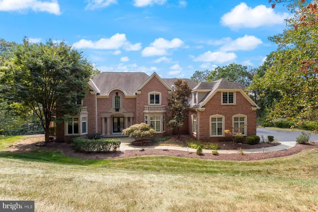 an aerial view of a house with backyard space and swimming pool