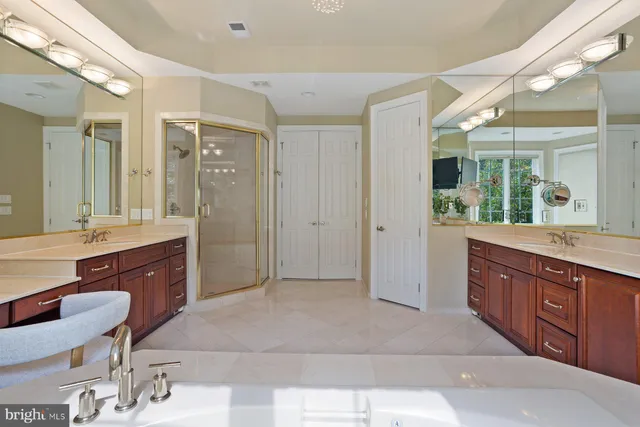 a living room with furniture potted plant kitchen view and a large window