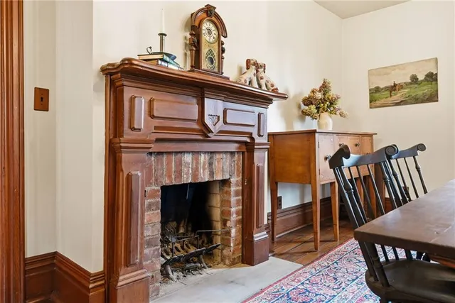 a view of hall way with furniture and fireplace