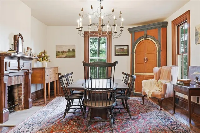 a view of a dining room with furniture a chandelier and wooden floor