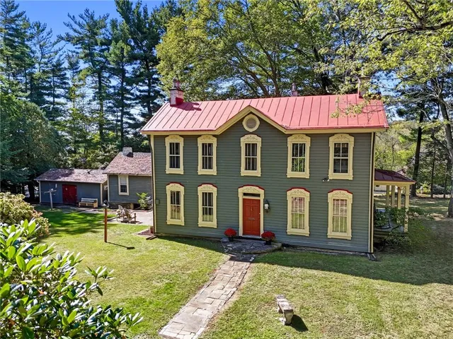 a front view of a house with garden
