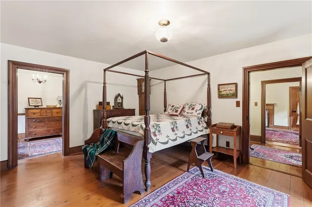 a view of a bedroom with furniture and window