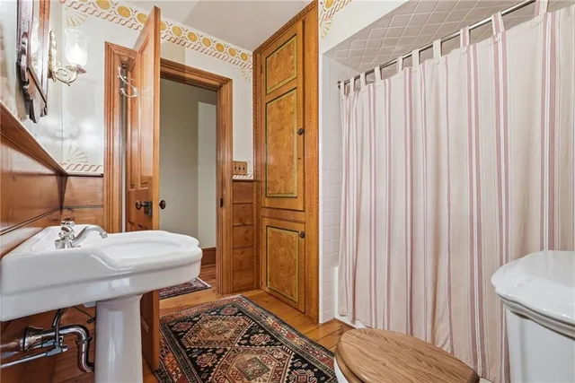 a bathroom with a sink a mirror and a shower curtain