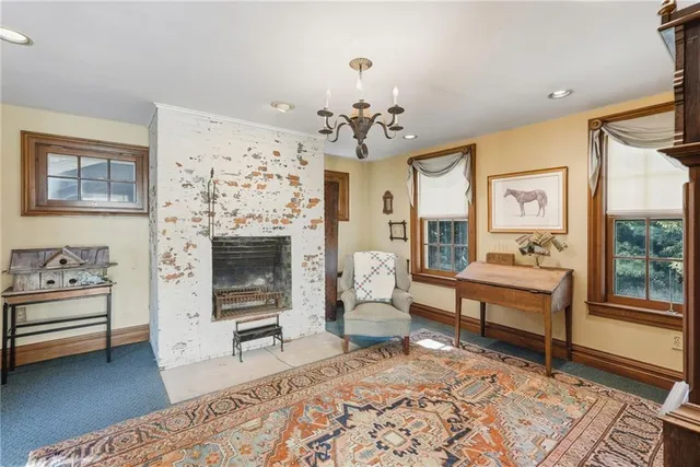 a bedroom with furniture and a fireplace