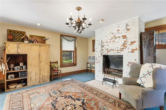 a living room with furniture a rug and a fireplace