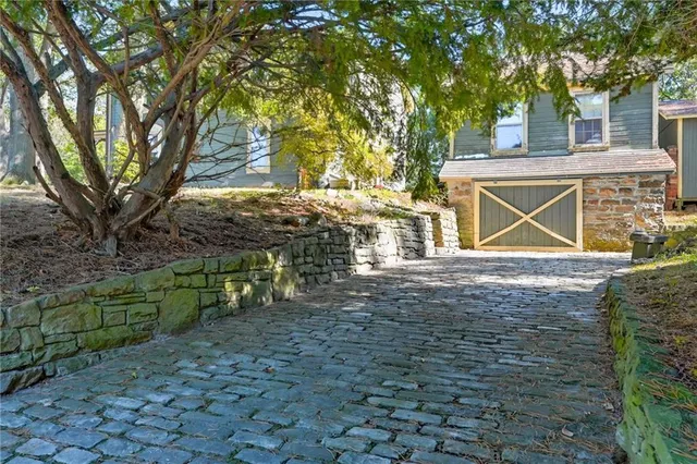 a view of house with backyard and trees