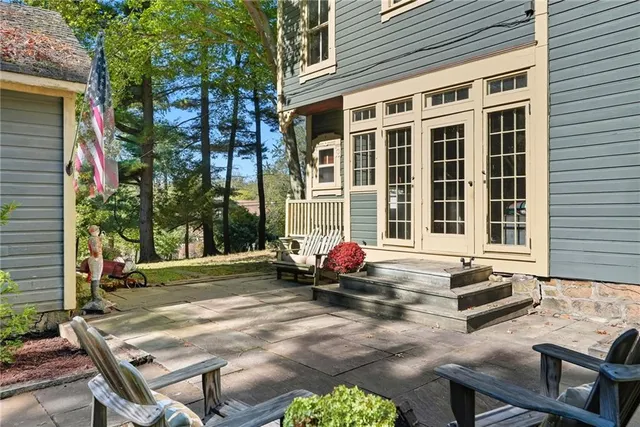 a front view of a house with outdoor seating