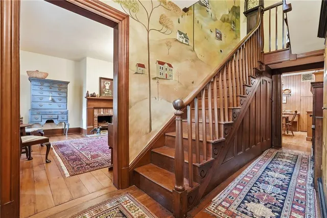 a view of staircase with wooden floor and a rug