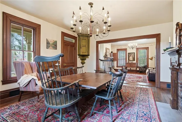 a view of a dining room with furniture a chandelier and wooden floor