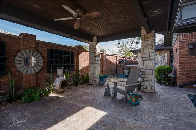 a view of a porch with chairs and potted plants