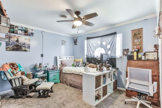 700 Sherri Street Ridgecrest, CA 93555 - Photo 17 of 34 a bed room with furniture and a large window