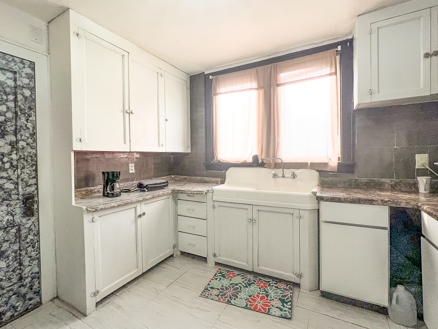 415 South 3rd Street Rochelle, IL 61068 - Photo 7 of 28 a kitchen with a sink window and cabinets