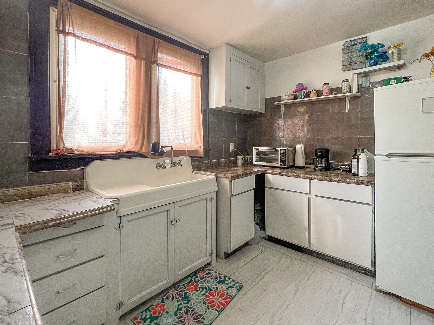 415 South 3rd Street Rochelle, IL 61068 - Photo 8 of 28 a kitchen with sink cabinets and white appliances