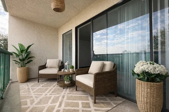 a living room with furniture and a potted plant