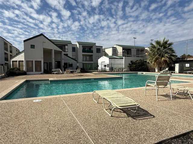 a view of a house with swimming pool and porch with furniture