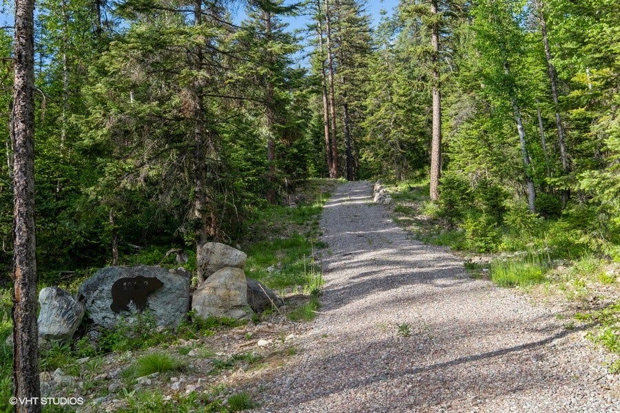 19132 High Rd Lane Bigfork, MT 59911 - Photo 1 of 22 driveway entry with custom entry signage