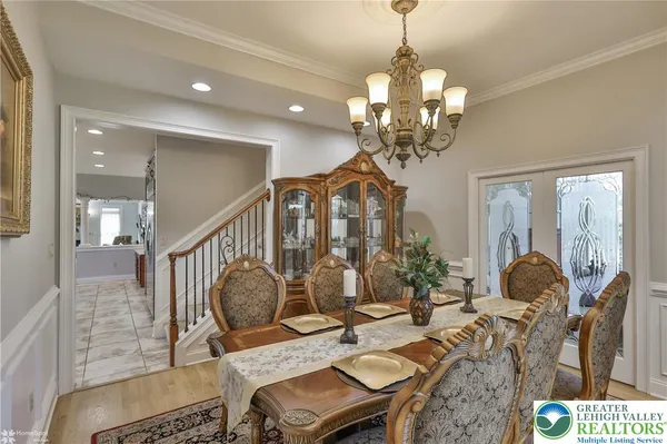a view of a a dining room with furniture window and wooden floor