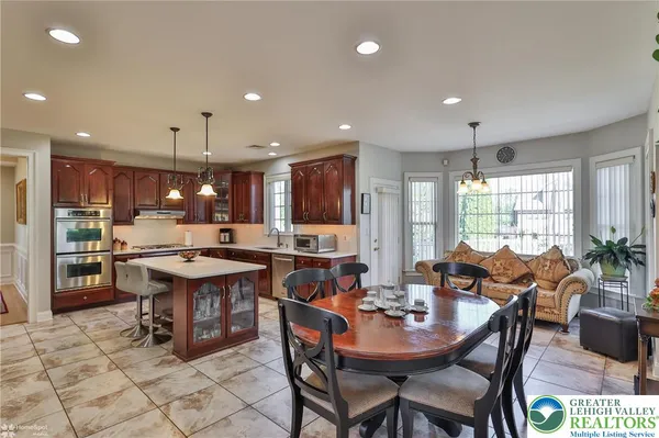 a kitchen with stainless steel appliances wooden cabinets and a stove top oven