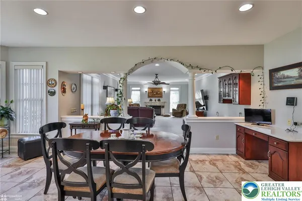 a living room with furniture and a ceiling fan