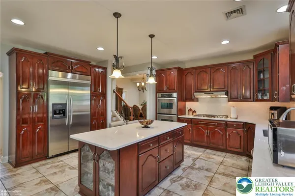 a living room with furniture kitchen and a flat screen tv