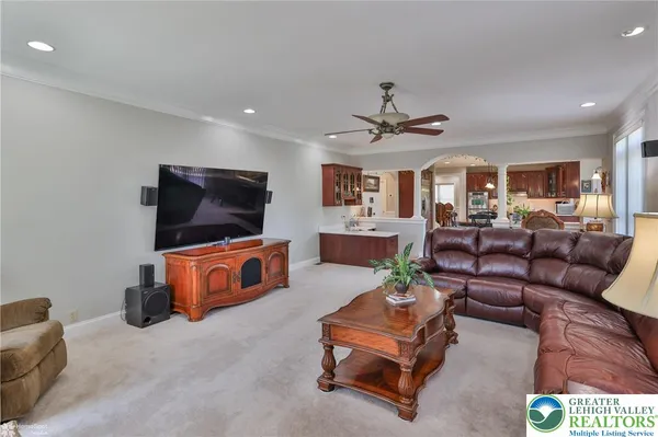 a living room with furniture a window and a chandelier
