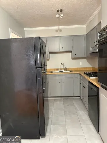 a kitchen with stainless steel appliances a refrigerator and cabinets