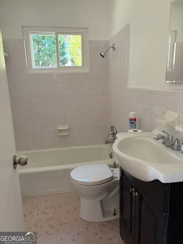 a bathroom with a sink a toilet and a bathtub