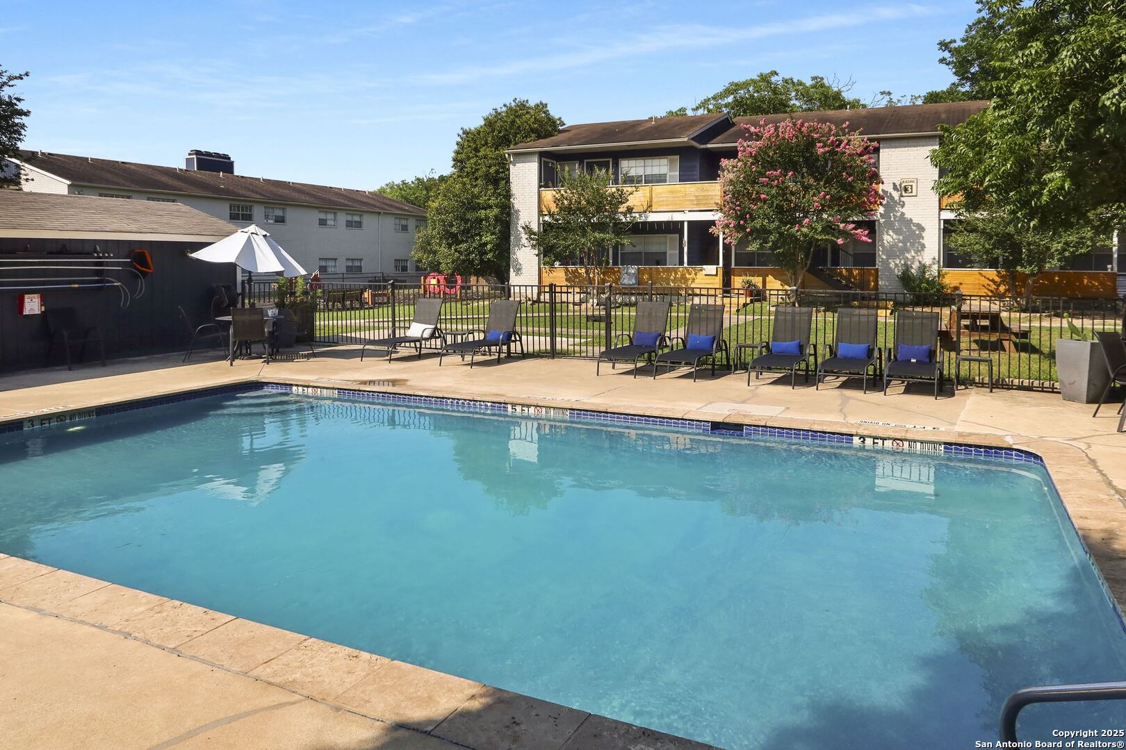 a view of a swimming pool with a lawn chairs