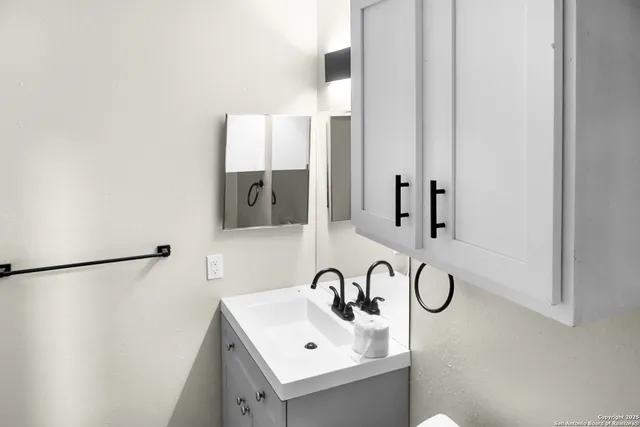a bathroom with a sink and mirror