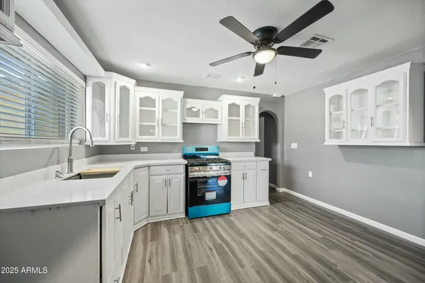 a kitchen with stainless steel appliances granite countertop a sink stove and refrigerator