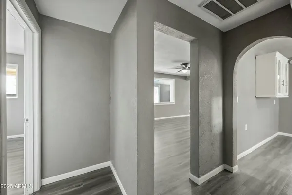 a view of empty room with wooden floor