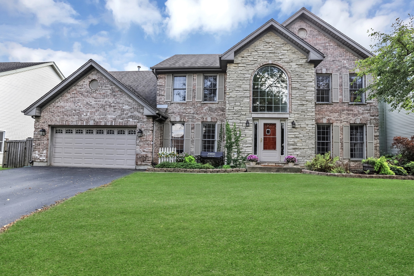 909 Pearson Road Cary, IL 60013 - Photo 1 of 1 a front view of a house with a garden and yard