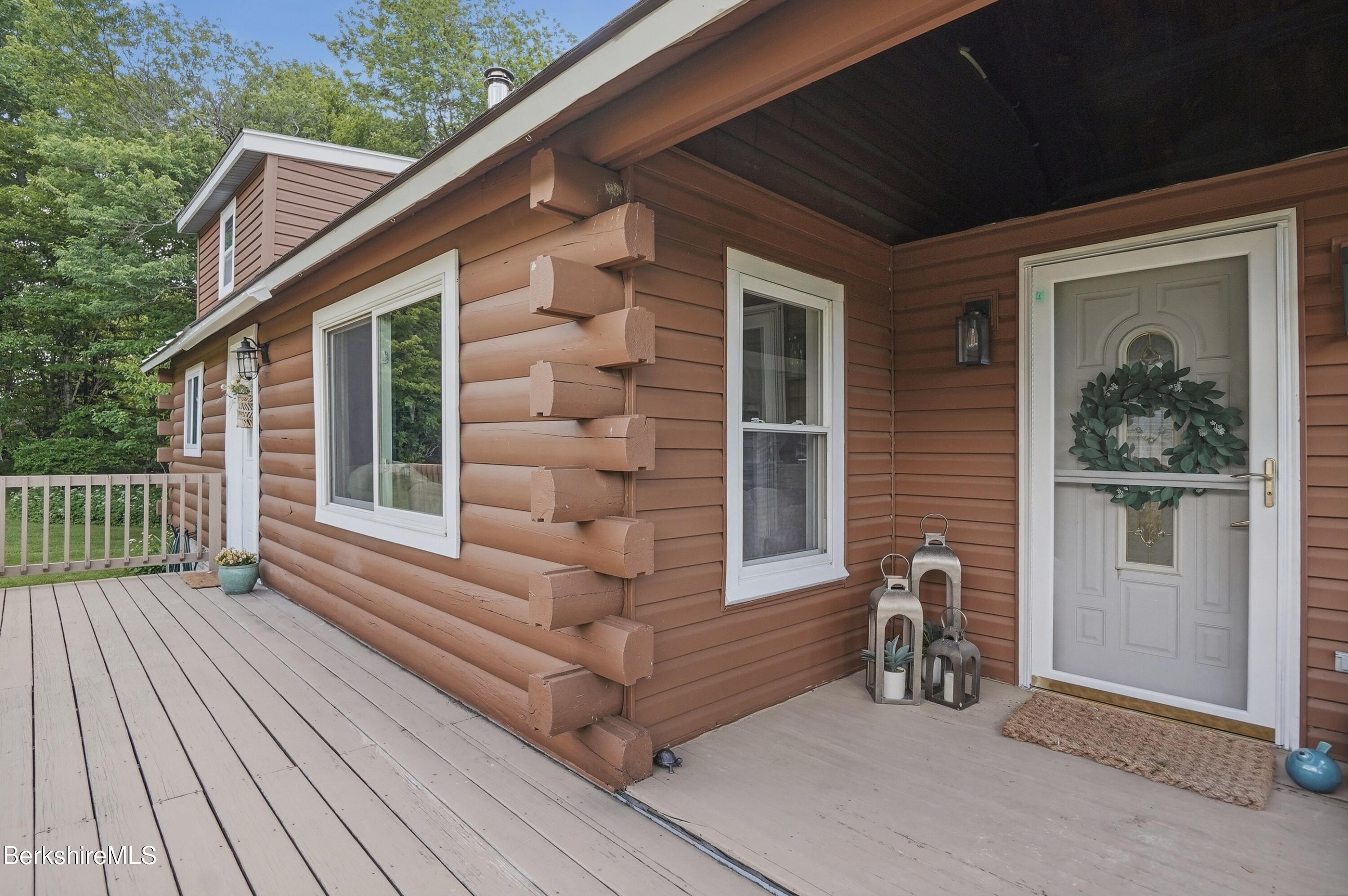 4 David Drive Peru, MA 01235 - Photo 30 of 44 a view of a house with a large window and wooden fence
