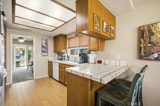 a kitchen with a table chairs cabinets and appliances