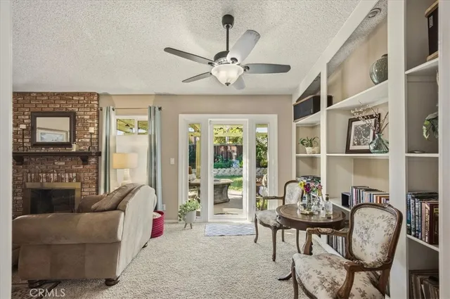 a living room with furniture a fireplace and a chandelier