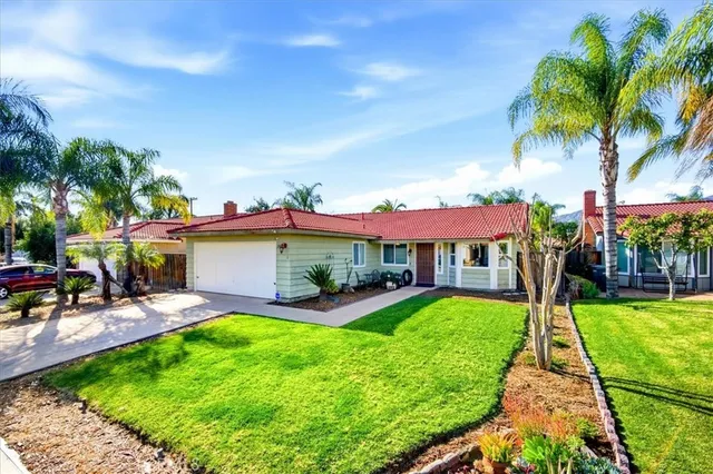 a view of a patio with a table and chairs under an umbrella