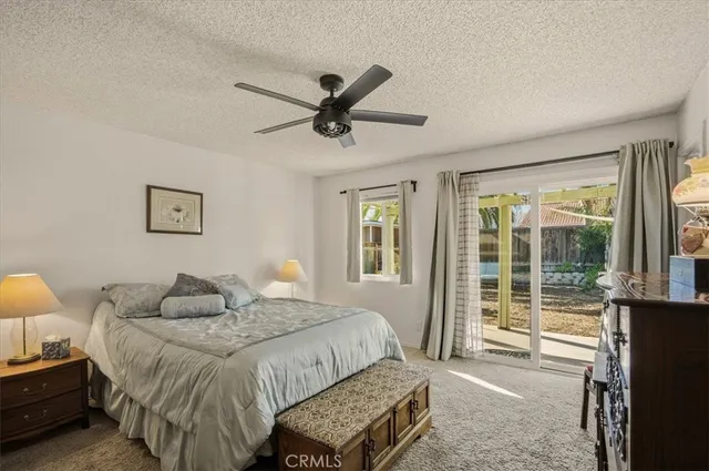 a bedroom with a bed and a lamp next to a window